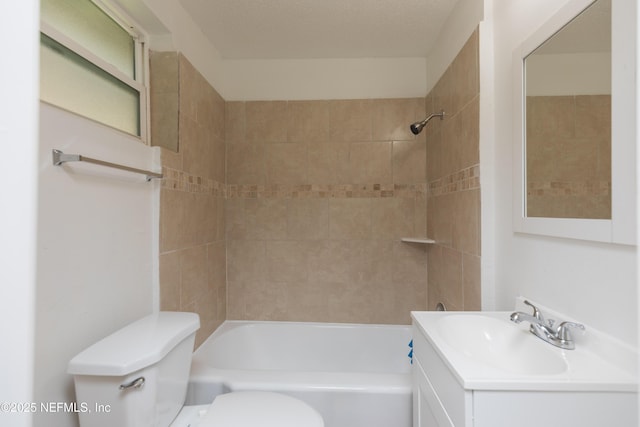 full bathroom with tiled shower / bath, vanity, and toilet