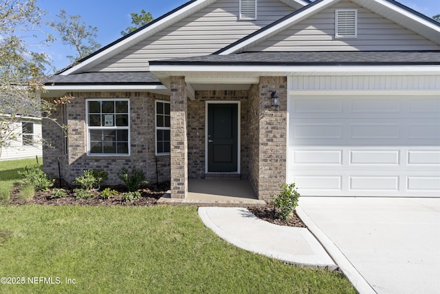 view of front of house with a garage and a front yard