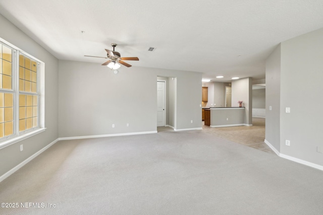 9831 Del Webb Pkwy Unit 3302, Jacksonville, FL 32256 - unfurnished living room featuring baseboards, ceiling fan, visible vents, and light carpet