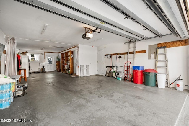 garage with a garage door opener and white fridge