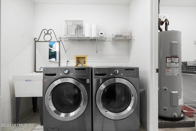 laundry area with washing machine and clothes dryer and water heater