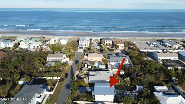 birds eye view of property with a water view and a view of the beach