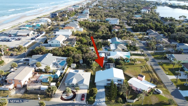 drone / aerial view featuring a water view and a view of the beach