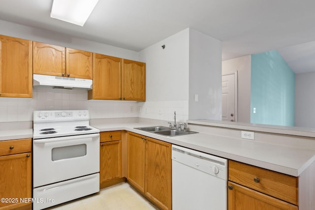 kitchen with white appliances, sink, and decorative backsplash