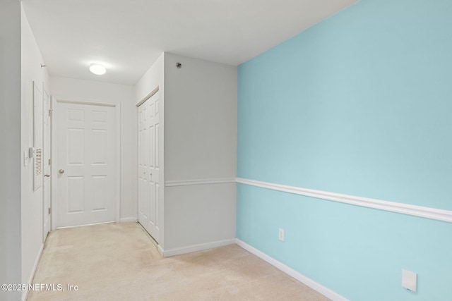 hall with light colored carpet