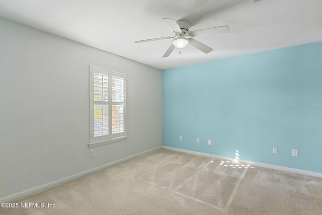 spare room with light colored carpet and ceiling fan