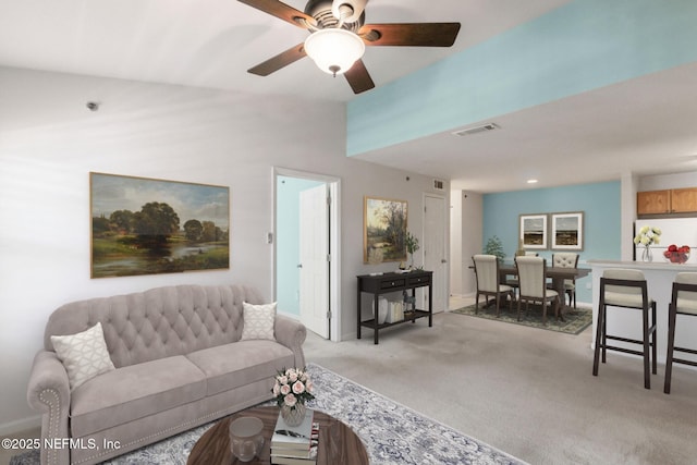 carpeted living room with ceiling fan