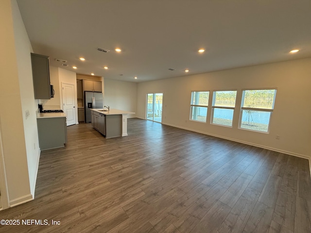 kitchen with visible vents, dark wood finished floors, recessed lighting, light countertops, and open floor plan