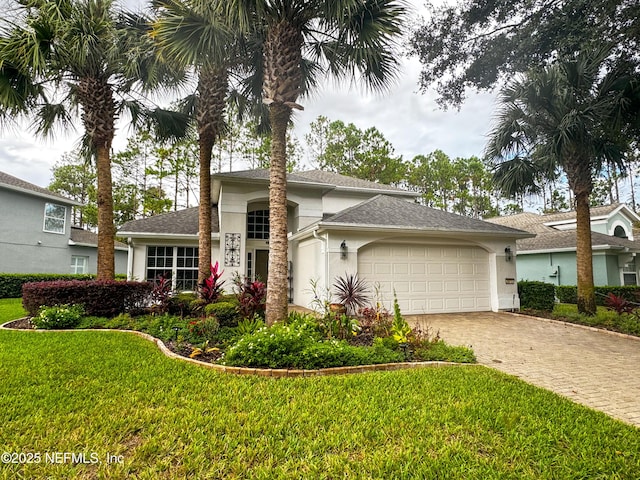 view of front of house with a garage and a front lawn