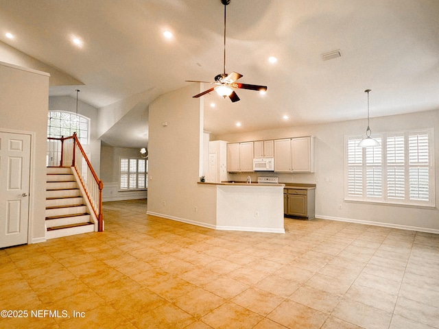 kitchen featuring pendant lighting, sink, white cabinets, ceiling fan, and kitchen peninsula