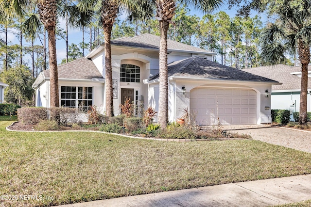 view of front of home featuring a garage and a front lawn