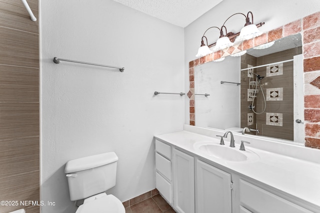 bathroom with tile patterned floors, toilet, a textured ceiling, a tile shower, and vanity