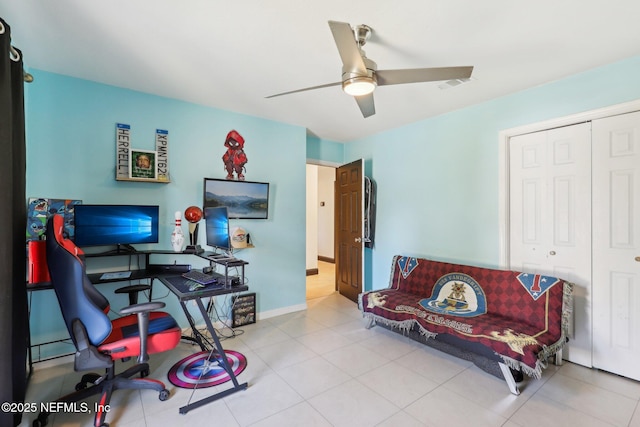 office area with light tile patterned floors and ceiling fan