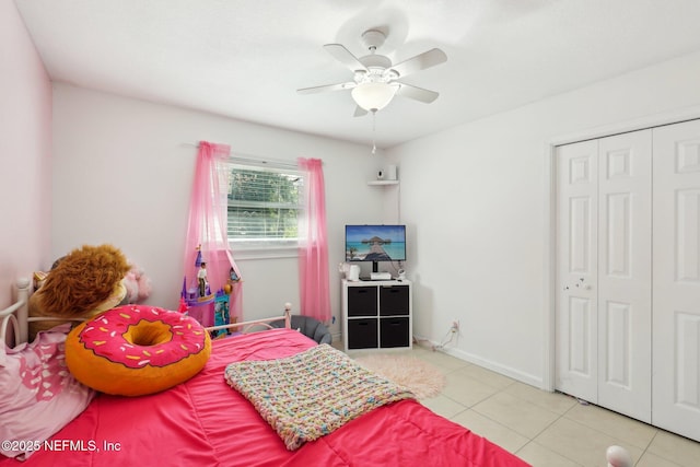 bedroom with a closet, ceiling fan, and light tile patterned flooring