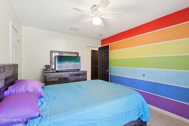 bedroom featuring light tile patterned flooring and ceiling fan