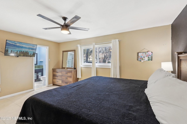 bedroom with ceiling fan, ensuite bath, and light tile patterned floors