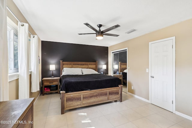 bedroom with ceiling fan and light tile patterned floors