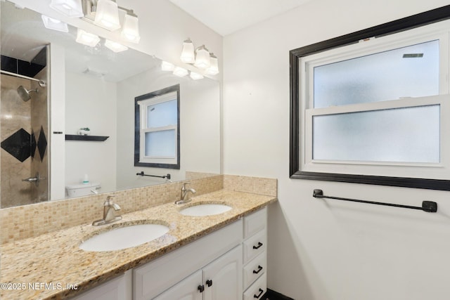 bathroom featuring vanity, toilet, decorative backsplash, and a tile shower