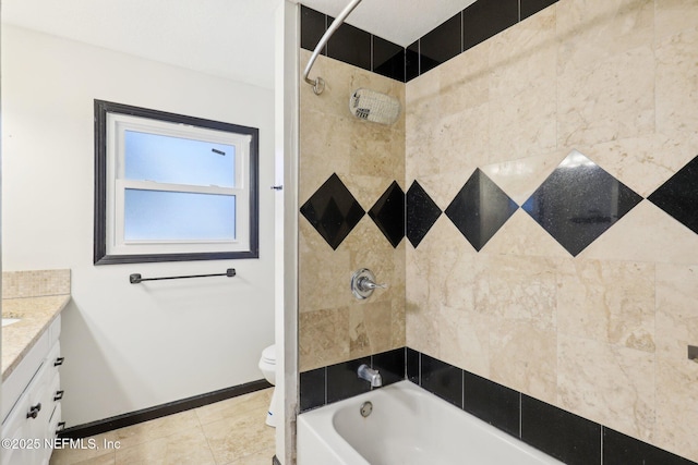 full bathroom with vanity, tile patterned floors, toilet, and tiled shower / bath