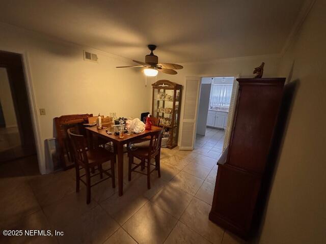 tiled dining space featuring ceiling fan