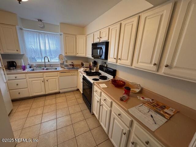 kitchen with sink, white appliances, white cabinets, and light tile patterned flooring