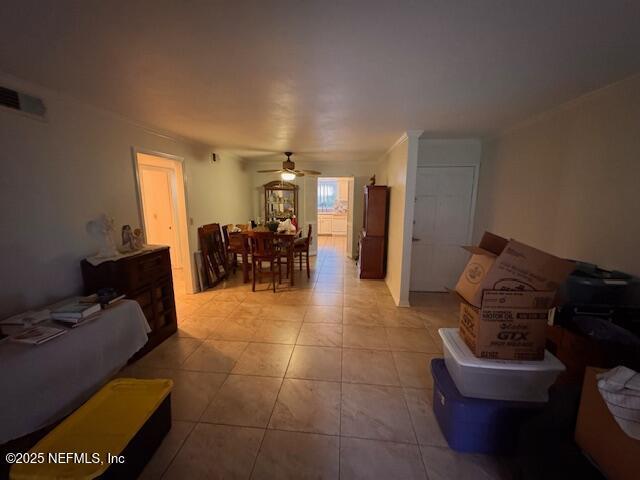 tiled living room with ceiling fan