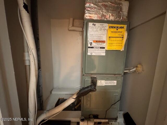 utility room featuring heating unit