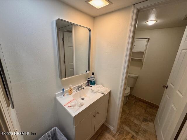 bathroom featuring vanity and toilet