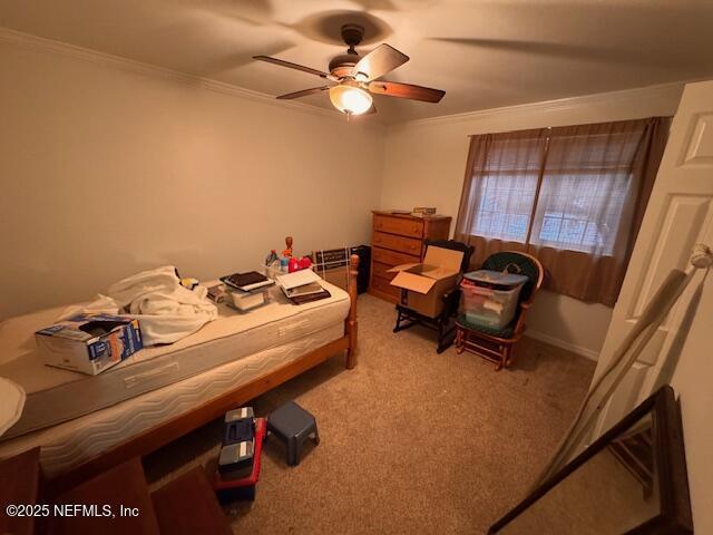 bedroom featuring crown molding, ceiling fan, and carpet