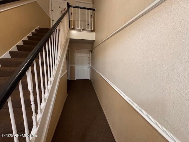 stairway featuring a high ceiling