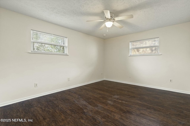 unfurnished room with ceiling fan, dark hardwood / wood-style floors, a textured ceiling, and a wealth of natural light