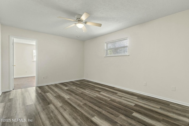 empty room featuring a textured ceiling, ceiling fan, and dark hardwood / wood-style flooring