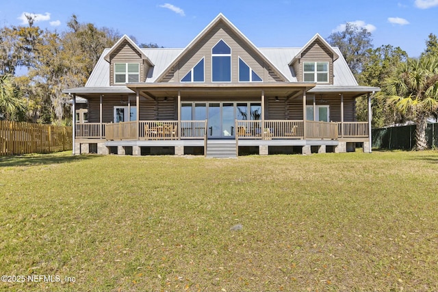 view of front of home with fence, metal roof, and a front yard