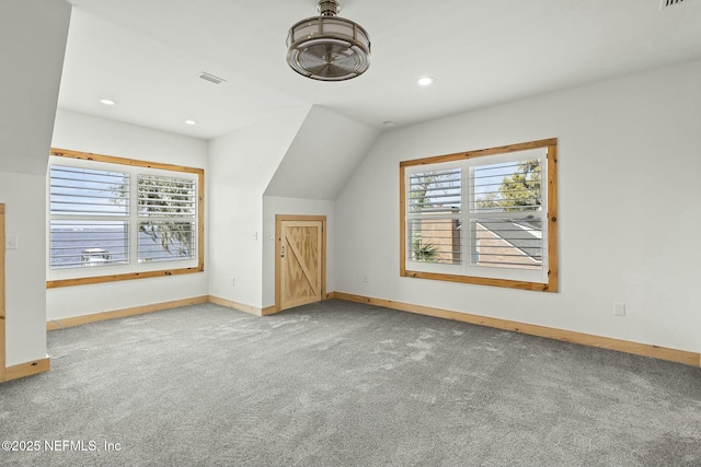 bonus room featuring carpet, plenty of natural light, visible vents, and baseboards