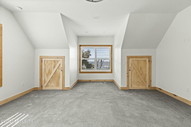 bonus room featuring vaulted ceiling, carpet flooring, and baseboards