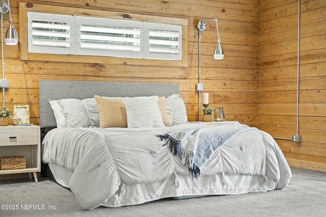 bedroom with carpet, multiple windows, and wood walls