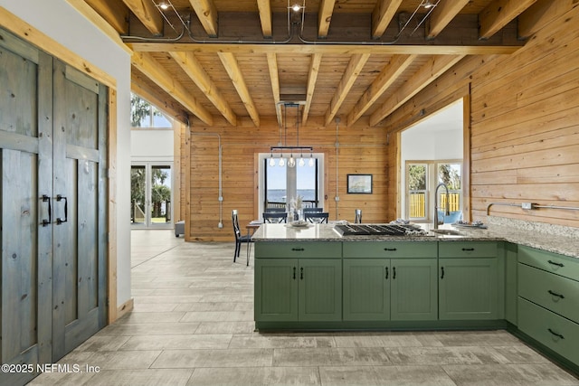 kitchen featuring a wealth of natural light, wooden ceiling, stainless steel gas stovetop, and green cabinets