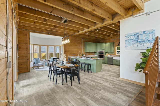 dining space featuring light wood-style flooring, wood ceiling, beam ceiling, wood walls, and a notable chandelier