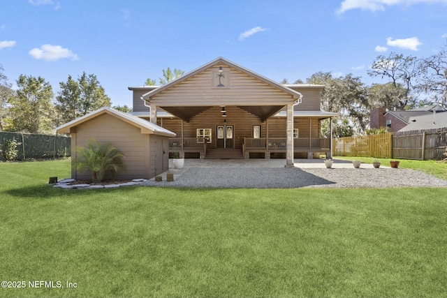 back of property featuring a yard and fence