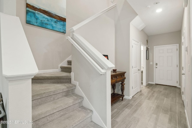 staircase with wood-type flooring