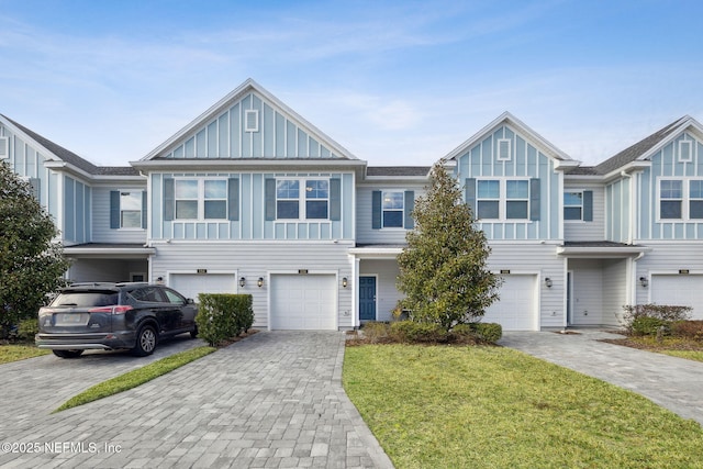 view of property with a garage and a front lawn