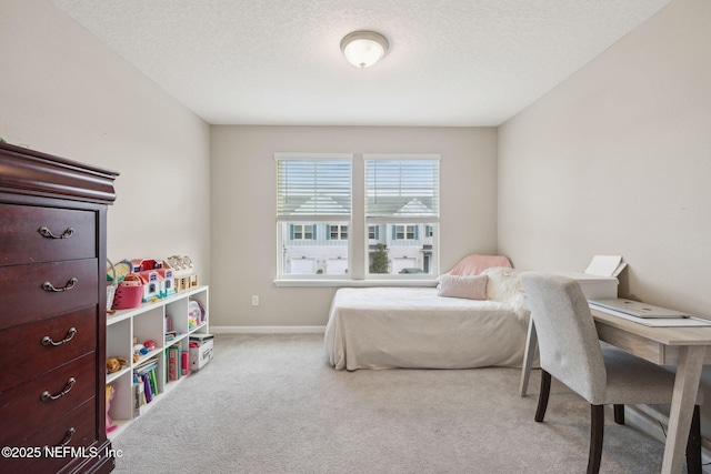 bedroom featuring light carpet and a textured ceiling