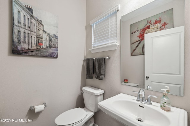 bathroom with sink and toilet