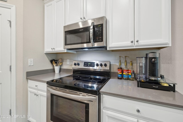 kitchen with appliances with stainless steel finishes and white cabinets