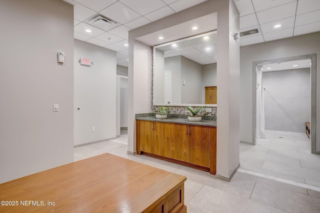 bathroom featuring vanity, a paneled ceiling, and tile patterned floors