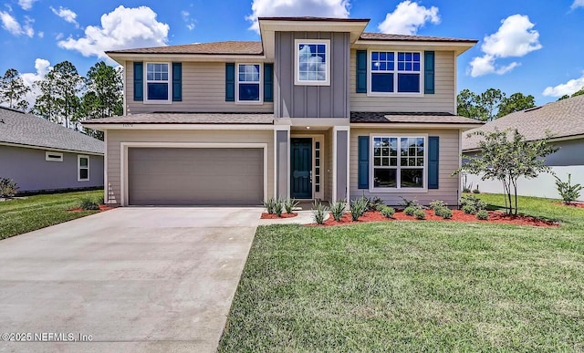 view of front facade featuring board and batten siding, a front yard, driveway, and an attached garage