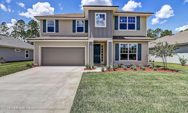 view of front of home with a garage and a front lawn