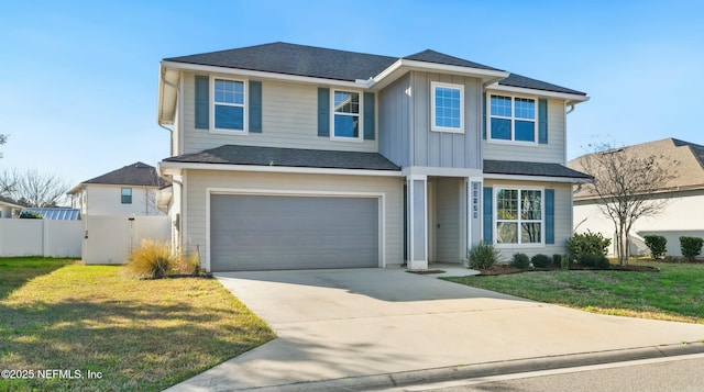 view of front of house with an attached garage, board and batten siding, a front yard, fence, and driveway