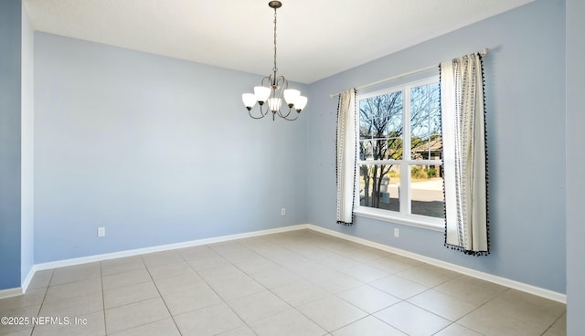 spare room featuring baseboards, a notable chandelier, and light tile patterned flooring