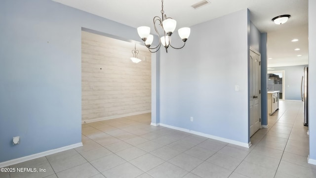 empty room with a notable chandelier, light tile patterned floors, recessed lighting, visible vents, and baseboards